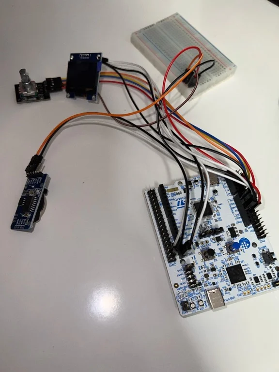 Hardware setup - NUCLEO-U545RE-Q with OLED display, Rotary Encoder, DS3231 RTC module, and breadboard