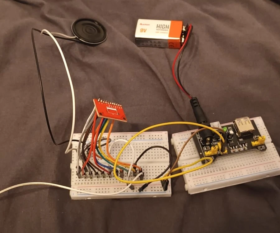 PAM8403 Amplifier connected to a speaker (left), 9v Battery connected to a Power Supply (right)